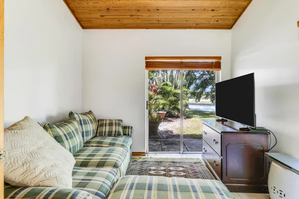 a bedroom with a bed and flat screen tv
