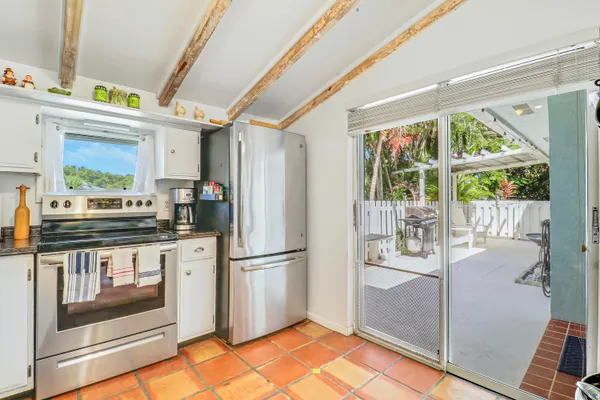 a kitchen with stainless steel appliances granite countertop a refrigerator and a stove