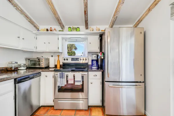 a kitchen with refrigerator and window
