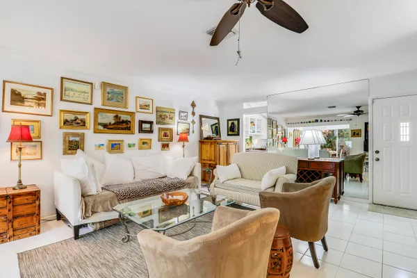 a living room with furniture and ceiling fan