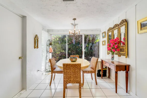 a view of a dining room with furniture large windows and wooden floor