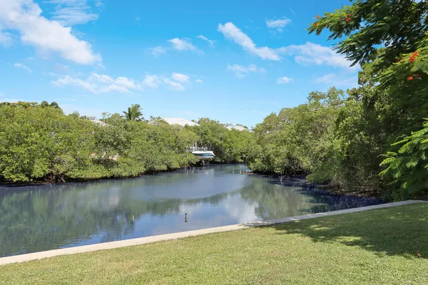 a view of a lake with houses in the back