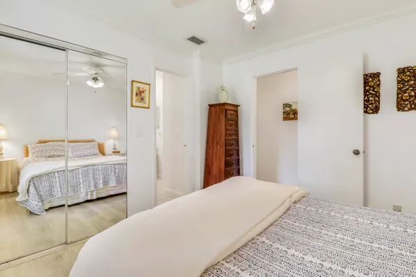 a bedroom with a bed and a mirror