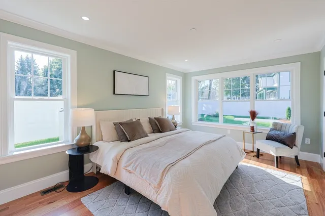 a bed sitting in a bedroom next to a window