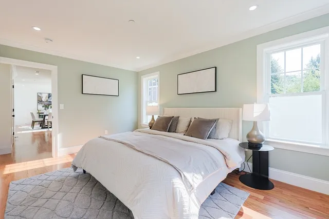 a bedroom with a bed and a painting on the wall