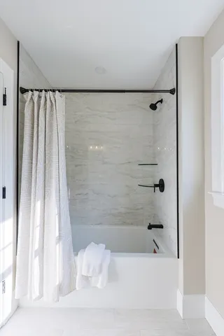 a bathroom with a bathtub and a shower