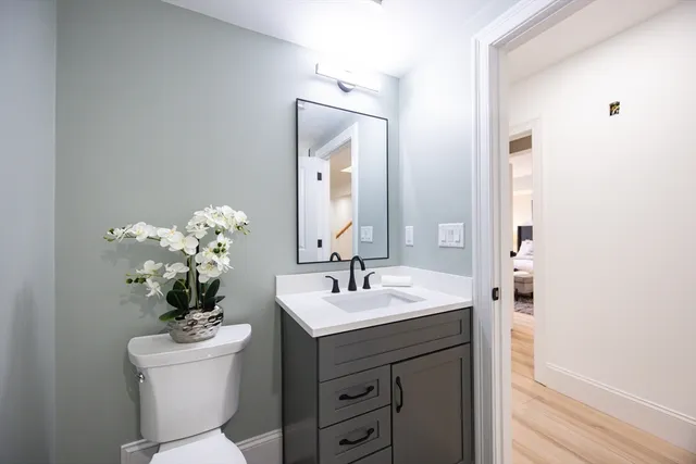 a bathroom with a sink vanity and a mirror