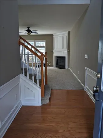 a view of entryway and hall with wooden floor