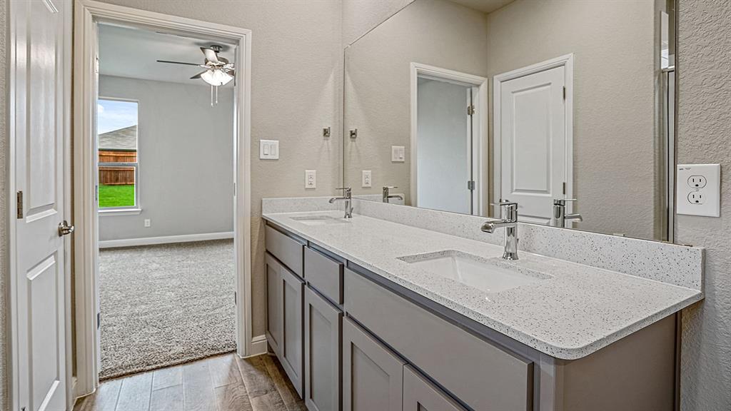 133 Hugo Court Rhome, TX 76078 - Photo 19 of 40 a bathroom with a sink and a mirror