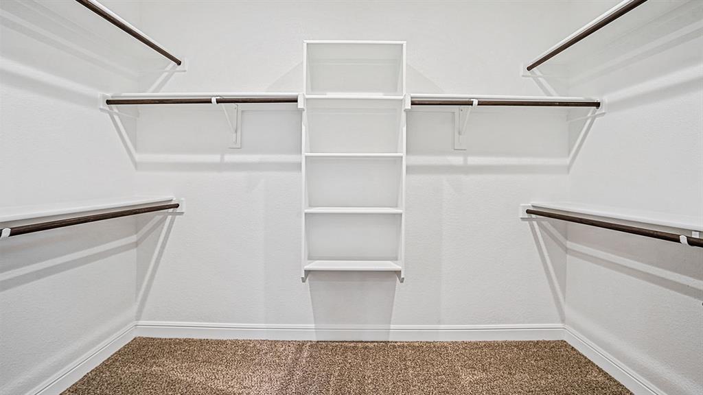 133 Hugo Court Rhome, TX 76078 - Photo 21 of 40 a view of walk in closet with empty racks