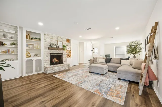 a living room with furniture large window and a fireplace