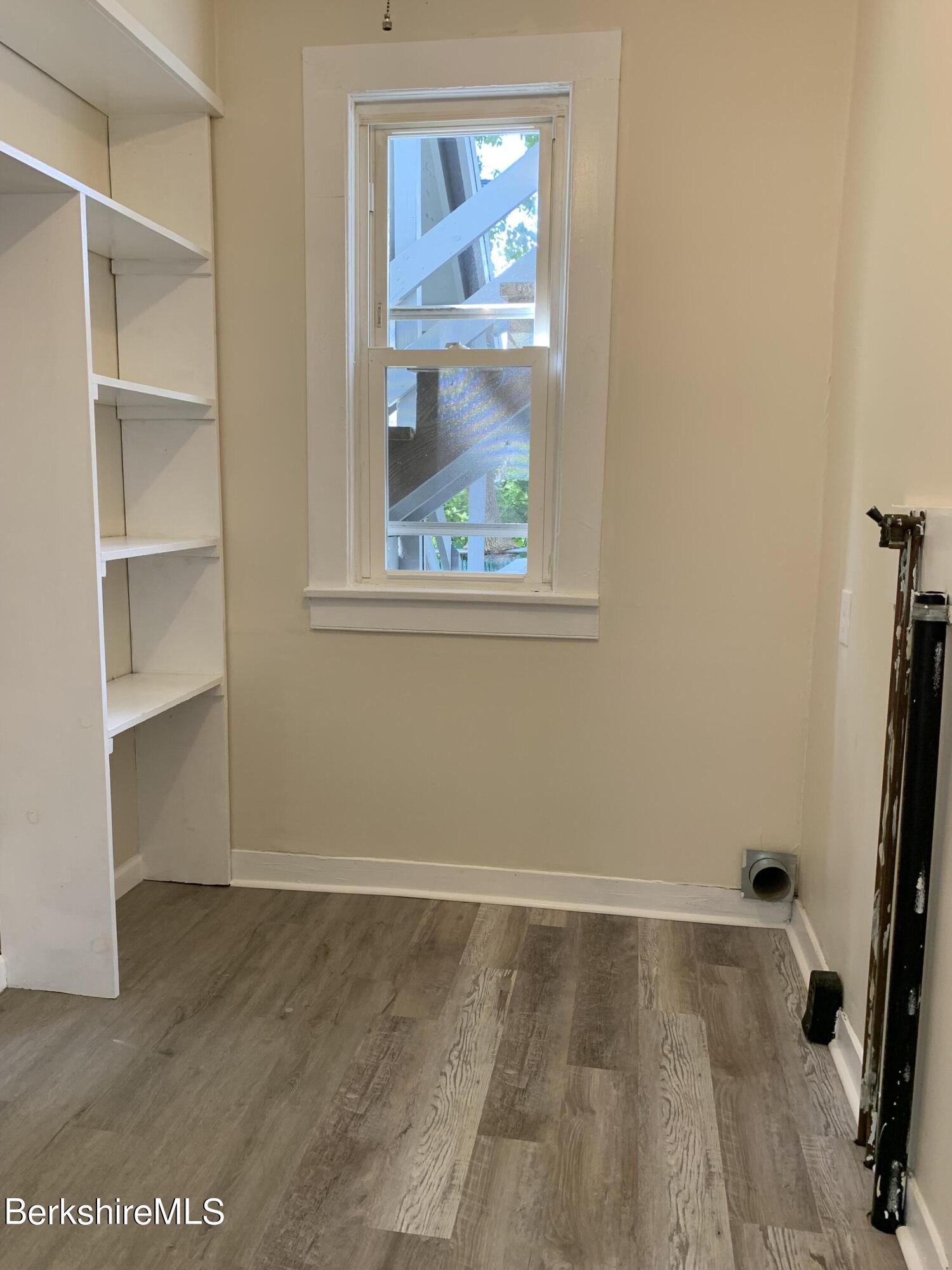 22 Copley Terrace Pittsfield, MA 01201 - Photo 17 of 42 a view of a room with wooden floor and windows