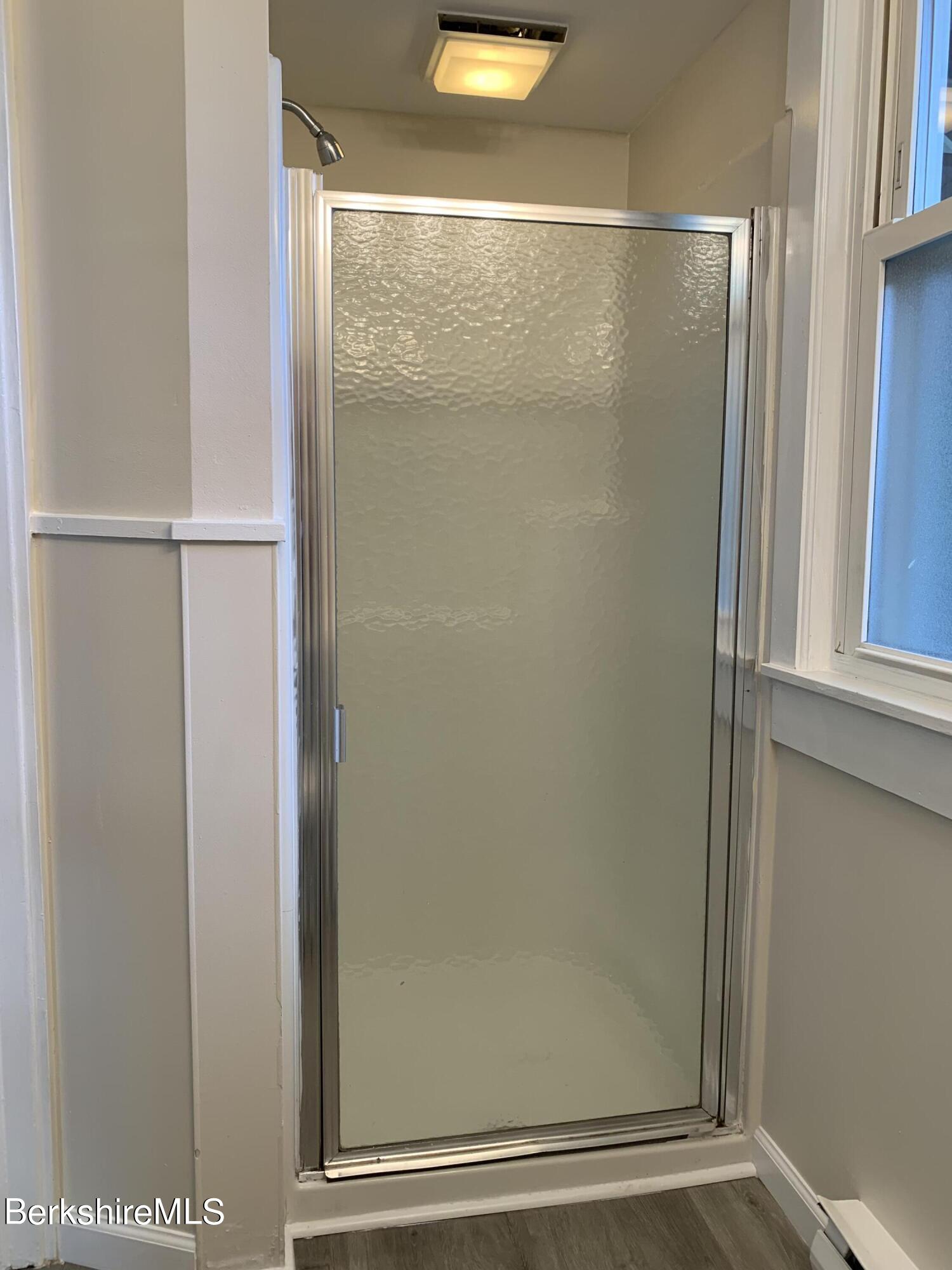 22 Copley Terrace Pittsfield, MA 01201 - Photo 23 of 42 a bathroom with a glass shower door