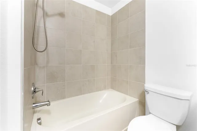 a bathroom with a white toilet and a shower