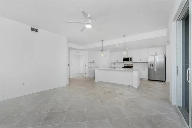 a large white kitchen with cabinets and stainless steel appliances