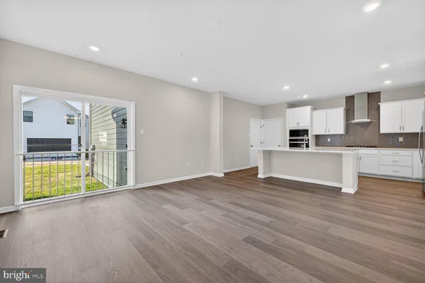 a view of kitchen with stainless steel appliances refrigerator sink microwave and cabinets