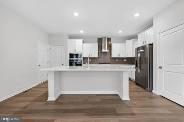 a kitchen with stainless steel appliances a refrigerator sink and microwave