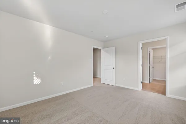 a spacious bathroom with a double vanity sink and mirror