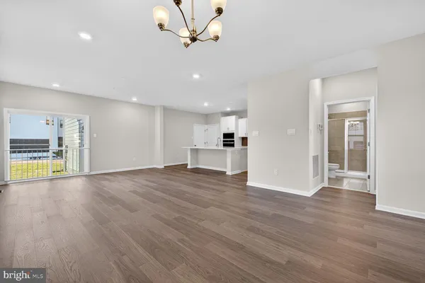 a view of a room with wooden floor and a window
