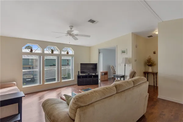 a living room with furniture dining table and wooden floor