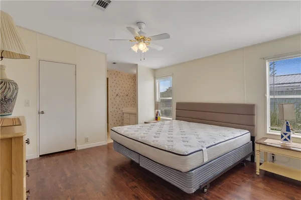 a living room with a bed and a chandelier