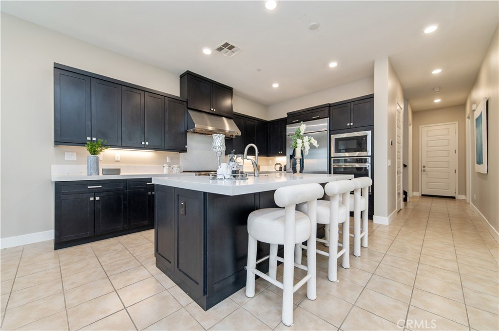 158 Scale Irvine, CA 92618 - Photo 4 of 23 a kitchen with stainless steel appliances kitchen island granite countertop a sink and cabinets