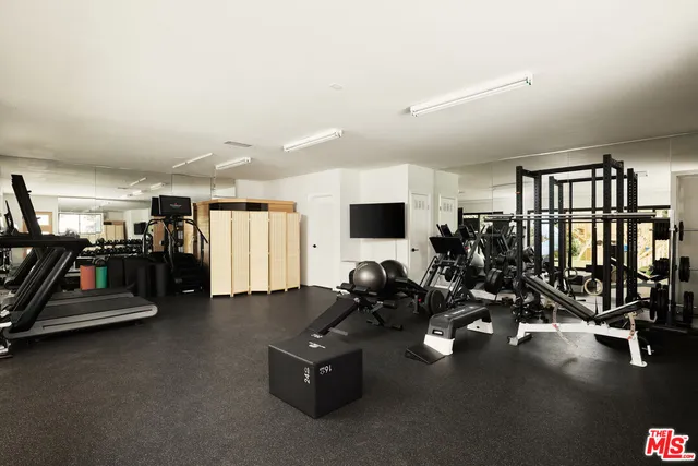 a room with gym equipment and a large window