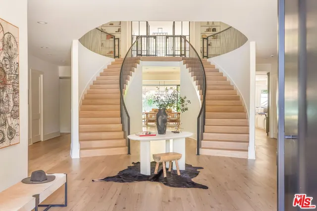a view of entryway and hall with wooden floor