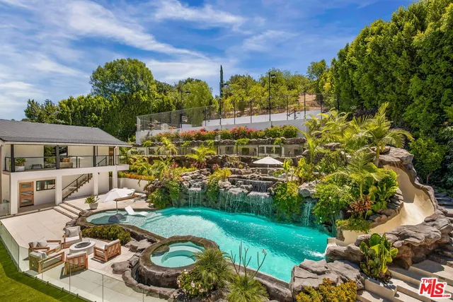 a view of a house with backyard sitting area and garden