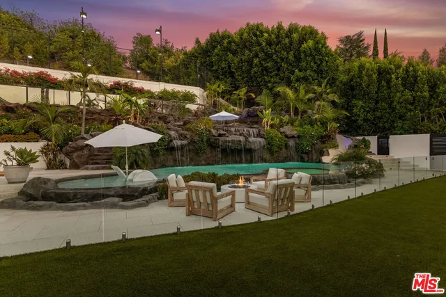 a view of a table and chairs under an umbrella
