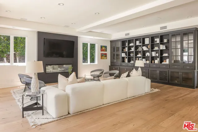 a living room with furniture window and a flat screen tv