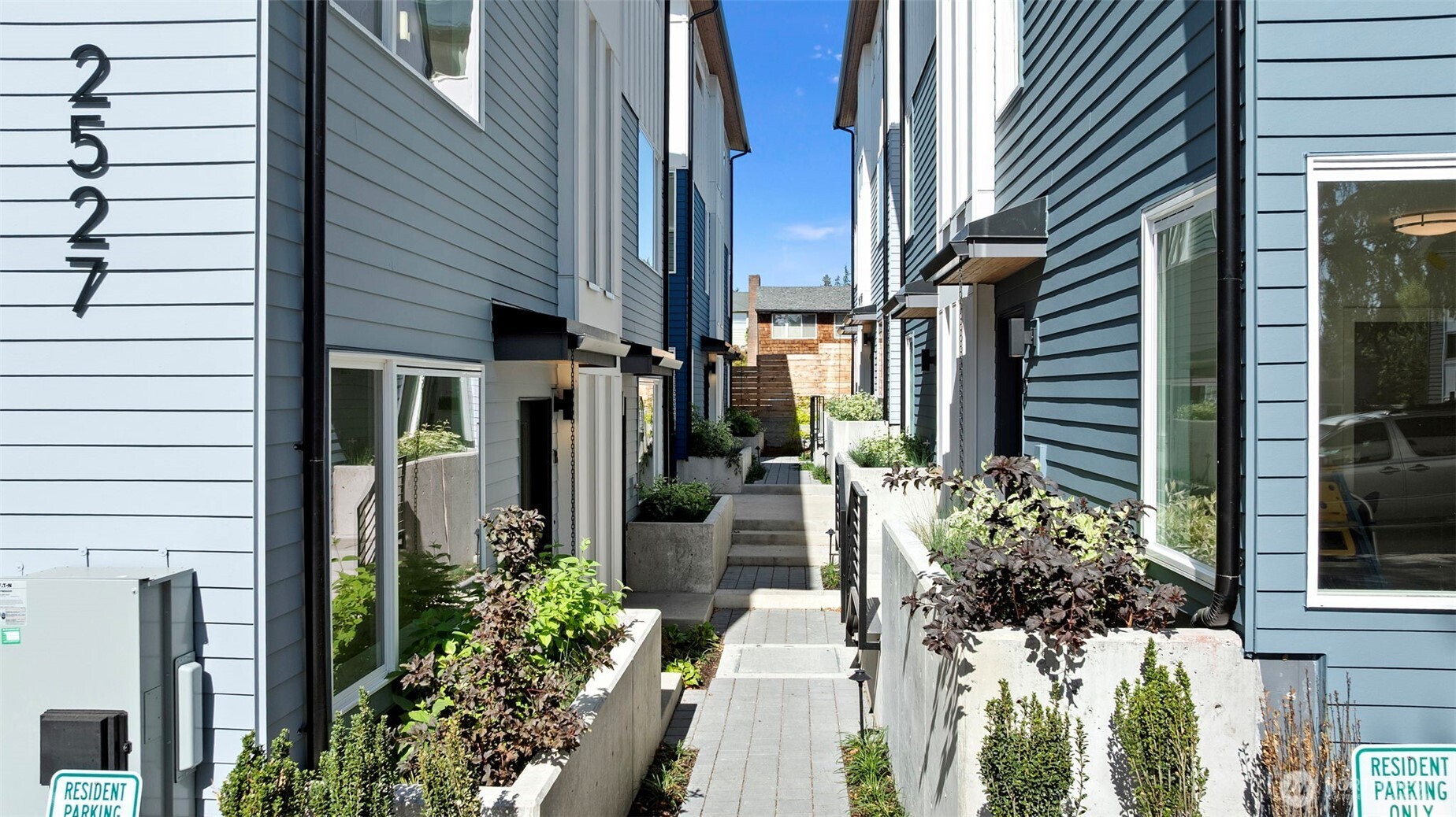 a view of a house with potted plants