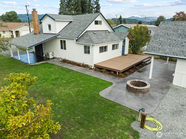 an aerial view of a house with garden space and street view