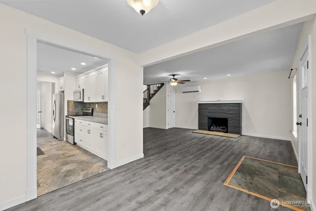 a view of kitchen with granite countertop stove top oven and refrigerator