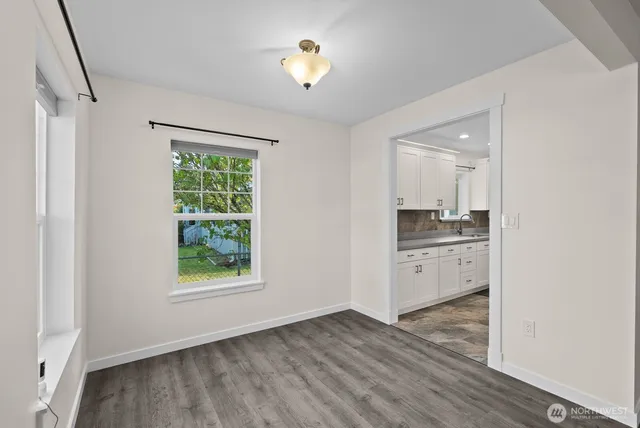a kitchen with a refrigerator and a stove top oven