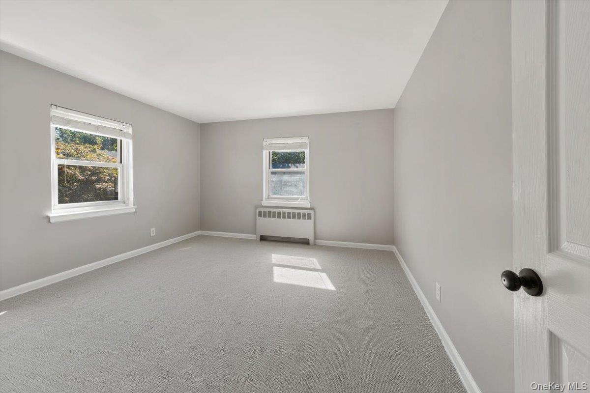 470 Tuckahoe Road, Unit 4B Yonkers, NY 10710 - Photo 14 of 17 Bedroom with radiator heating unit and carpet floors