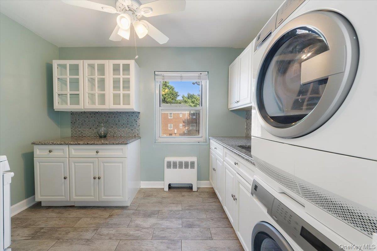470 Tuckahoe Road, Unit 4B Yonkers, NY 10710 - Photo 7 of 17 Washroom featuring stacked washing machine and dryer, radiator, cabinet space, and ceiling fan