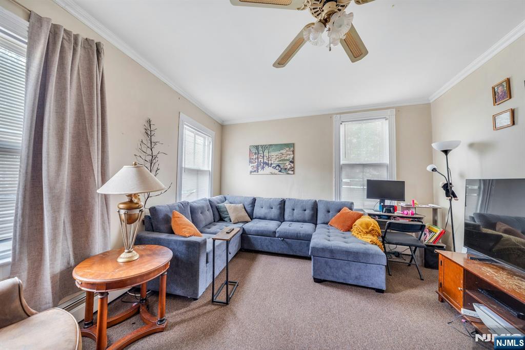 79 Washington Street Harrison, NJ 07029 - Photo 3 of 25 a living room with furniture and a chandelier