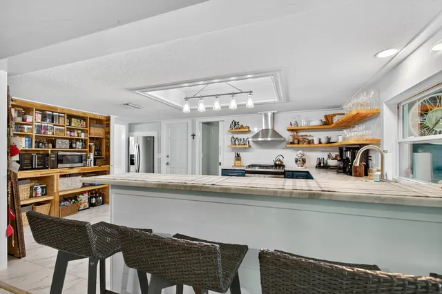 a bedroom with a bed and a potted plant