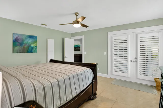 a bed room with a bed a television and a large window