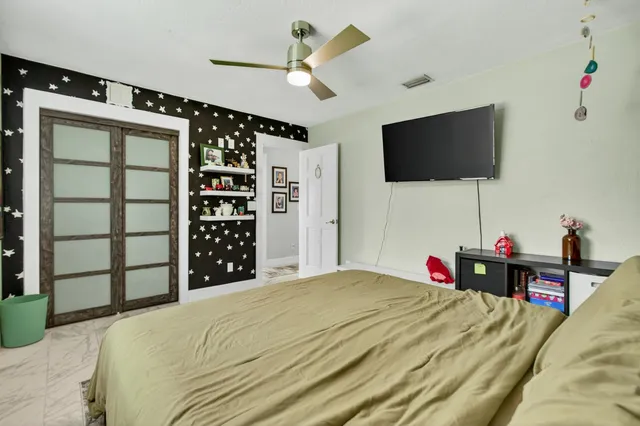 a view of a chair and table in backyard of the house