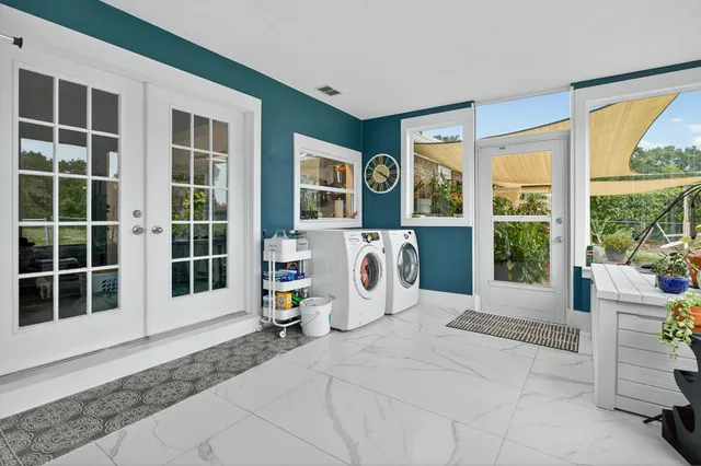 an aerial view of residential houses with outdoor space and swimming pool