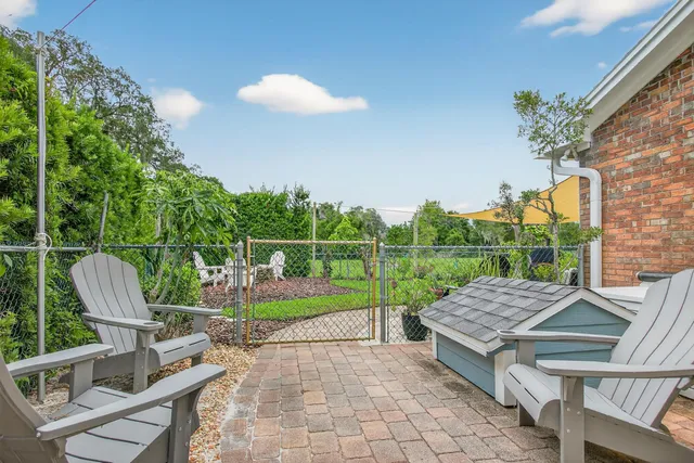 an aerial view of residential houses with outdoor space and ocean view