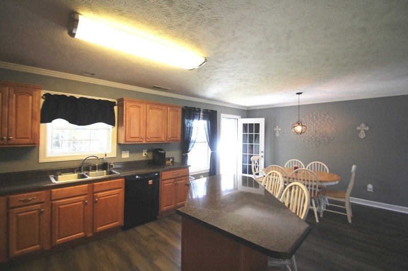 111 Oak Hollow Road Manchester, TN 37355 - Photo 5 of 17 a kitchen with granite countertop a table chairs stove and granite counter tops