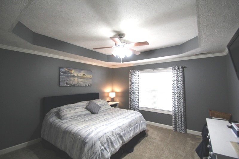 111 Oak Hollow Road Manchester, TN 37355 - Photo 8 of 17 a bedroom with a bed and a chandelier