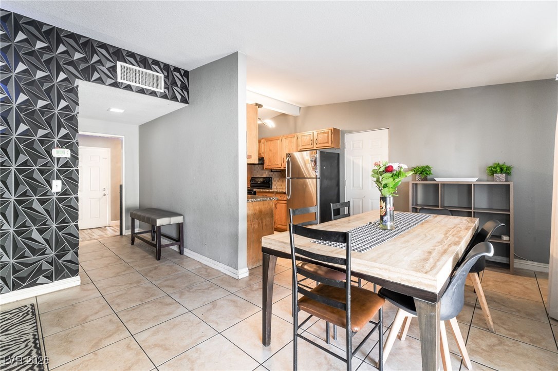 716 North 18th Street Las Vegas, NV 89101 - Photo 14 of 39 Dining area with vaulted ceiling and light tile patterned floors