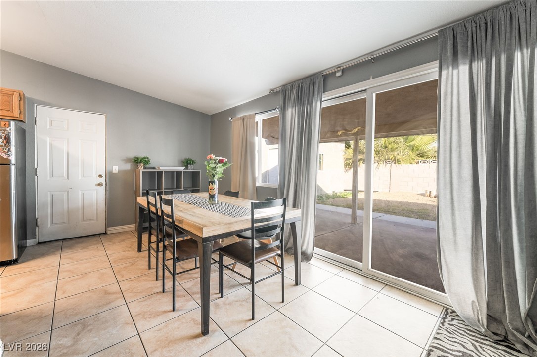 716 North 18th Street Las Vegas, NV 89101 - Photo 15 of 39 Dining room featuring light tile patterned flooring and lofted ceiling
