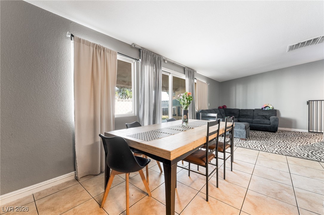 716 North 18th Street Las Vegas, NV 89101 - Photo 16 of 39 Dining space featuring a textured wall and light tile patterned floors