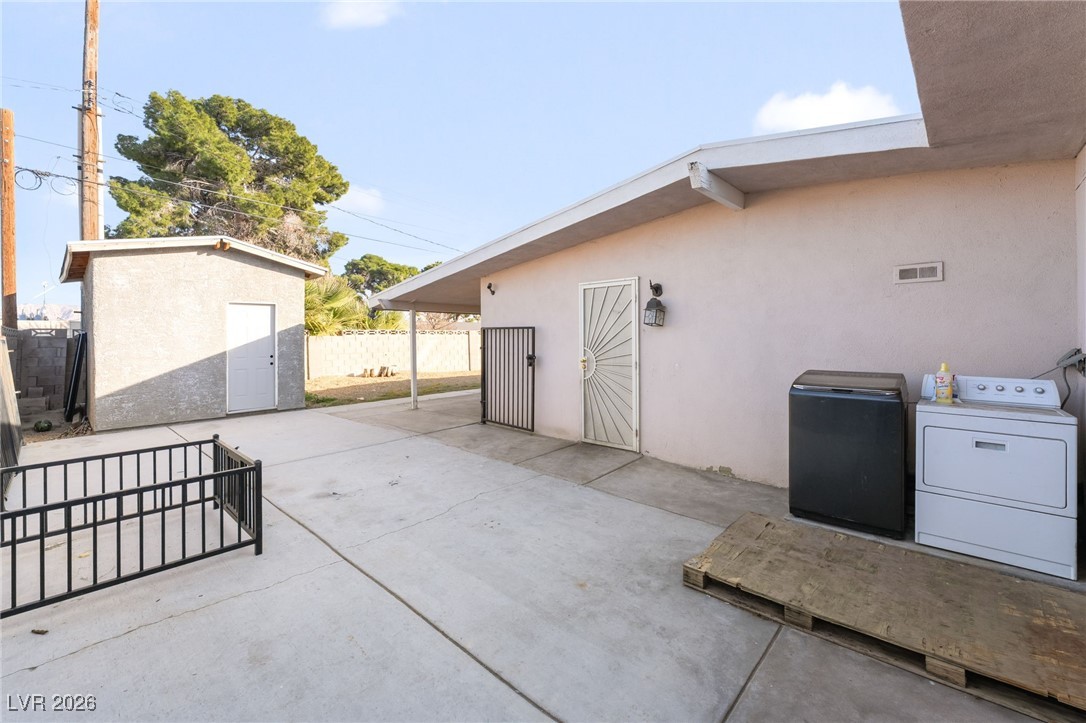 716 North 18th Street Las Vegas, NV 89101 - Photo 33 of 39 Fenced backyard with a patio area and a storage unit