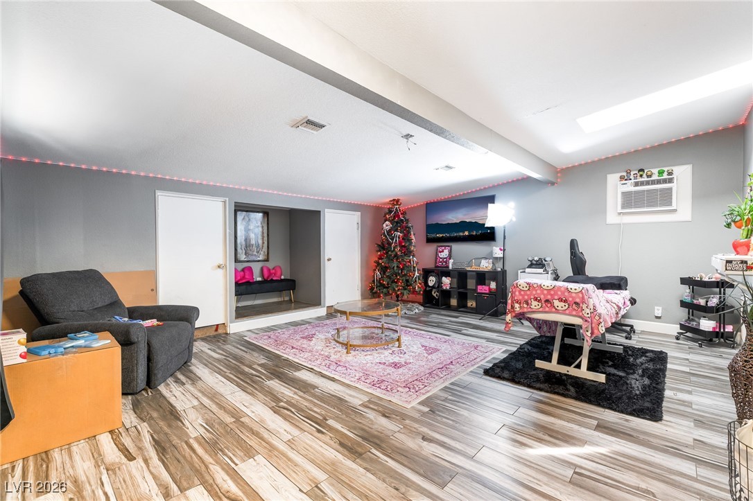 716 North 18th Street Las Vegas, NV 89101 - Photo 6 of 39 Living area featuring light wood-style floors and a wall mounted AC